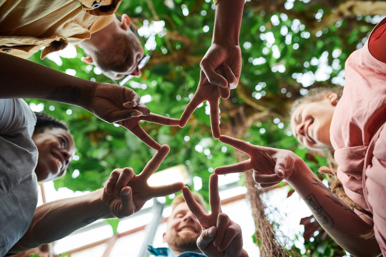 Low Angle Photography of People's Finger Doing Star Shape